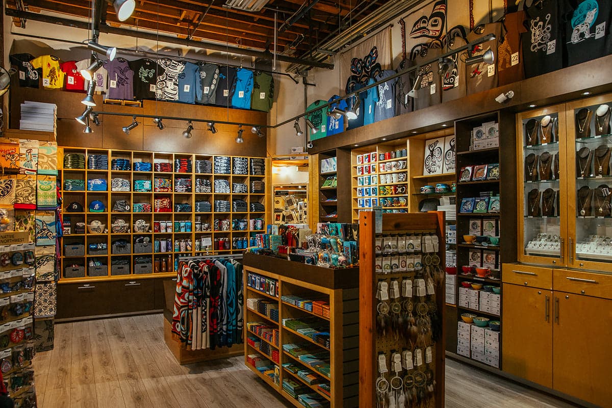 Photograph of the Wickaninnish Gallery store interior on Granville Island, showing shelves and counters with Indigenous-made goods